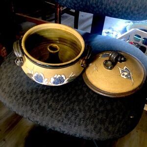 Pottery pot with lid and double handle brown in color with blue flowers painted